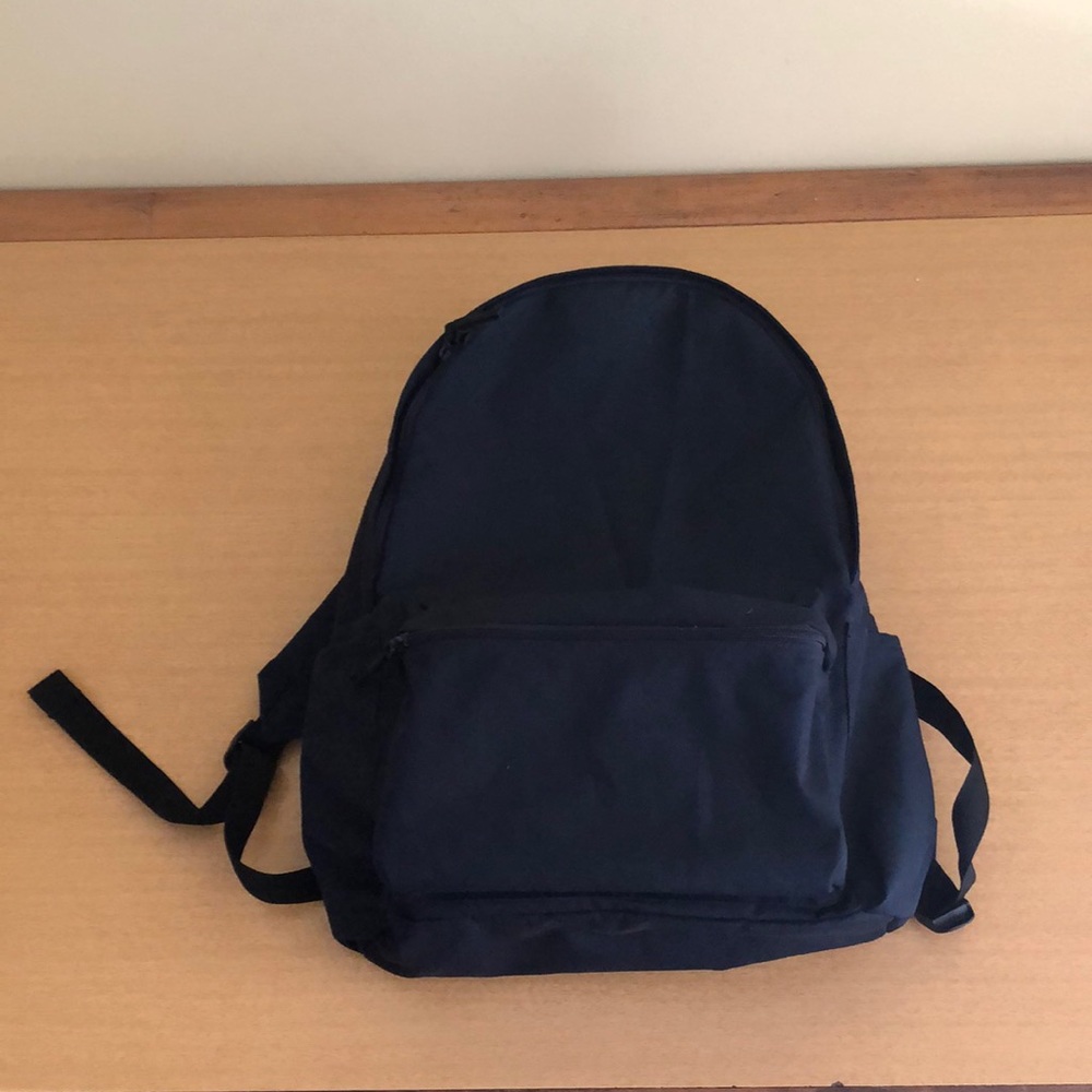 Muji book bag backpack, navy blue.  One large pocket and one small front pocket